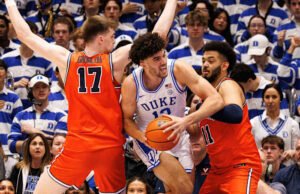 Evans dan Boozer membantu Duke No. 1 mengalahkan No. 11 Virginia 77-51 dan meraih unggulan teratas di Turnamen ACC