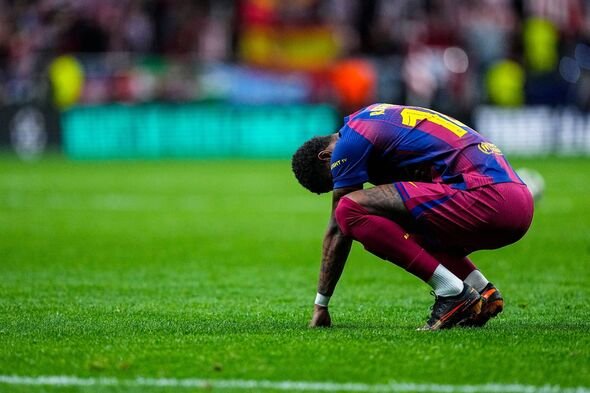 Seorang pemain sepak bola, mengenakan jersey biru dan merah, berlutut di lapangan hijau dan tampak sedang merenung. Seorang pemain sepak bola, mengenakan jersey biru dan merah, berlutut di lapangan hijau dan tampak sedang merenung.